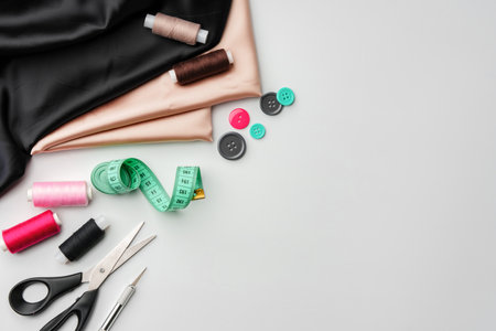 Crafting essentials for sewing projects displayed on a table with fabric, threads, and toolsの写真素材