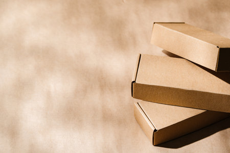 Stacked cardboard boxes on a neutral background in a shipping or packaging settingの写真素材