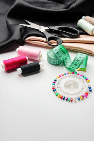 Crafting essentials for sewing projects displayed on a table with fabric, threads, and toolsの写真素材