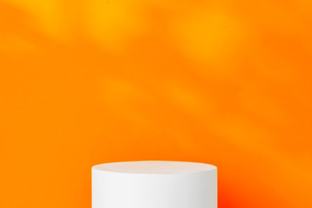White cylindrical display on a bright orange backgroundの写真素材
