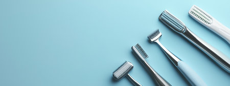 Various toothbrushes lined up on a blue background showcasing dental care tools for effective oral hygiene at homeの素材