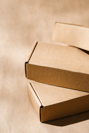 Stacked cardboard boxes on a neutral background in a shipping or packaging settingの写真素材