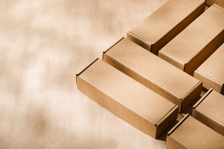 Brown cardboard boxes arranged on a neutral background during daylight hoursの写真素材