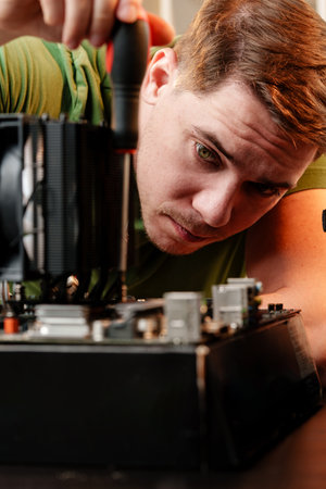 Man assembles a computer system unit at home