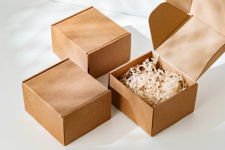 Display of brown cardboard boxes arranged uniquely with one box opened