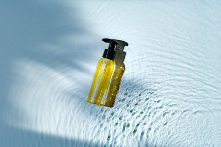 Skincare product bottle positioned against a light background with shadowsの写真素材