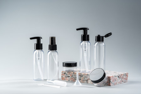 Elegant amber glass bottles displayed on a textured stone surface in a minimalist studio setting