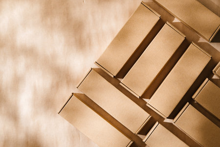 Brown cardboard boxes arranged on a neutral background during daylight hoursの写真素材
