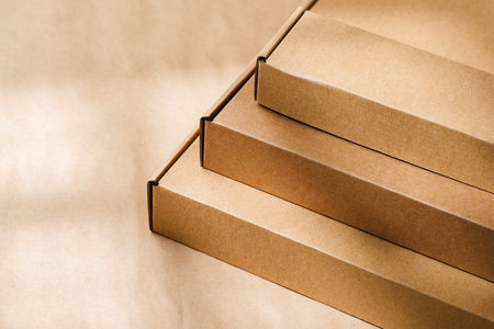 Stacked cardboard boxes on a neutral background in a shipping or packaging settingの写真素材