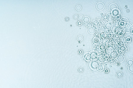 Gentle ripples form on a serene blue surfaceの写真素材