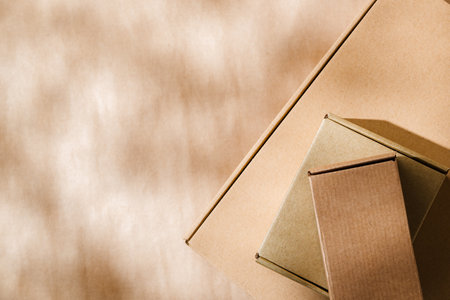 Stacked cardboard boxes on a neutral background in a shipping or packaging settingの写真素材