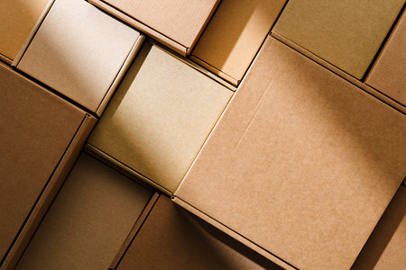Stacked cardboard boxes arranged in a neat pattern under natural light