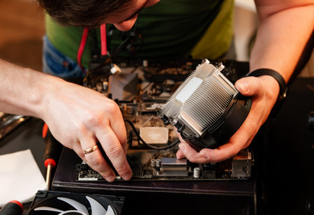 Close up of man repairing computer system unit