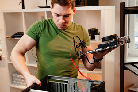 Man assembles a computer system unit at home