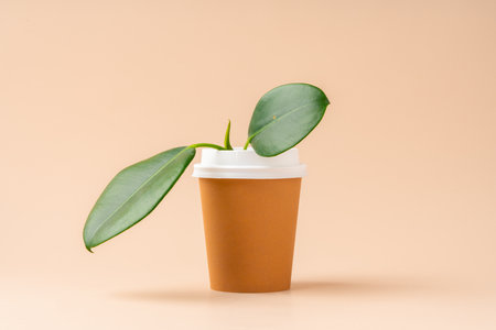 A coffee cup transforms into a planter with lush green leaves