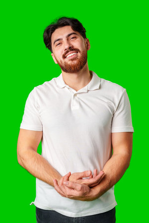 A man with a beard smiles confidently against a bright green backgroundの写真素材