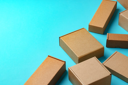 A collection of cardboard boxes arranged on a bright blue surfaceの写真素材