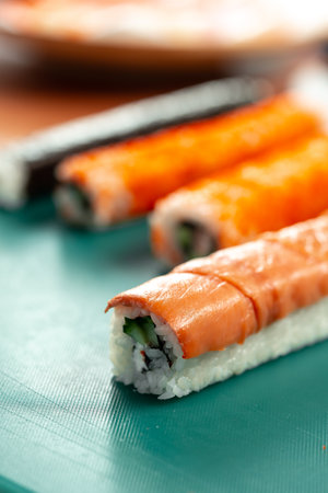 Preparing sushi rolls with fresh ingredients at a culinary studioの写真素材