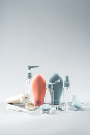 Variety of travel-sized containers displayed against a bright blue backgroundの写真素材