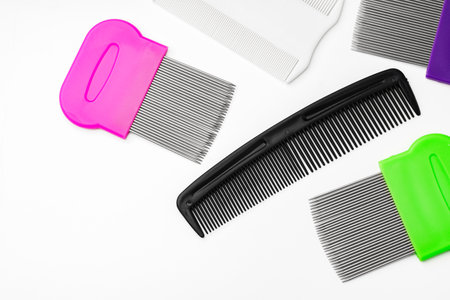 Colorful plastic and metal combs on a white background