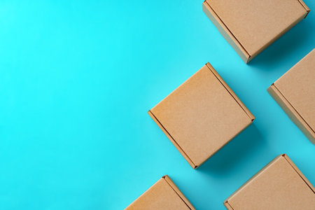A collection of cardboard boxes arranged on a bright blue surfaceの写真素材