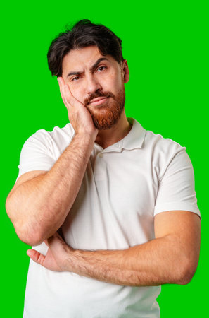 A man stands against a vibrant green backgroundの写真素材