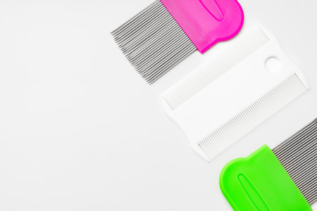 Colorful plastic and metal combs on a white backgroundの写真素材