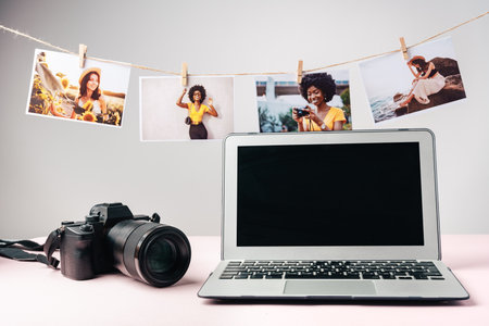 Laptop and camera on the table close up. Printing photosの写真素材