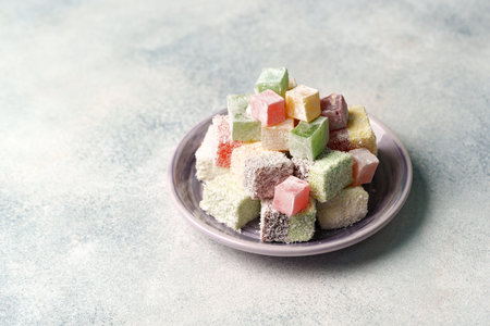 Colorful assortment of traditional confectionery displayed on a plate in a soft light settingの写真素材