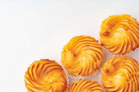 Freshly baked pastry treats beautifully arranged on a white background for a delightful dessert...