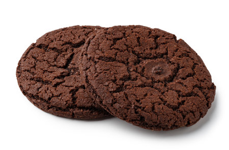 Soft chocolate cookies with a cracked texture on a white background, perfect for dessert or snack timeの写真素材