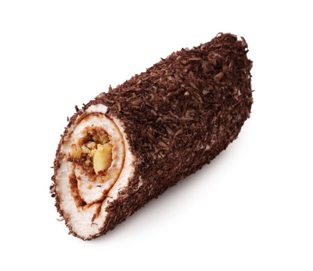 Chocolate roll cake filled with nuts and cream displayed on a clean surfaceの写真素材