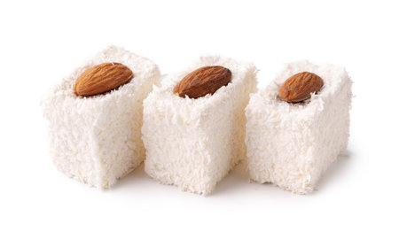 Delightful coconut sweets topped with almonds, perfect for celebrations and gatheringsの写真素材