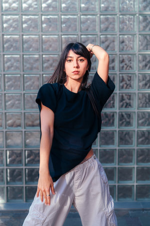 Model poses creatively in a stylish urban setting showcasing contemporary fashionの写真素材