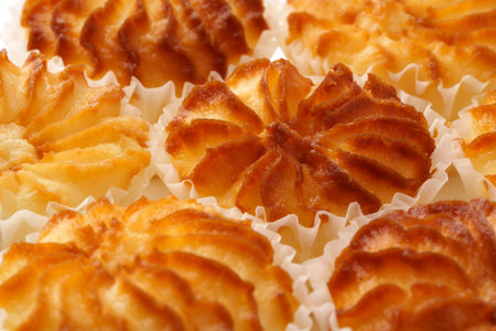 Deliciously baked pastry shells arranged on a platter with intricate designs showcasing golden...