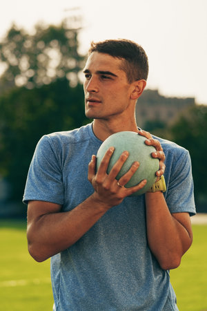 Athlete prepares to throw during outdoor training session on a sunny day