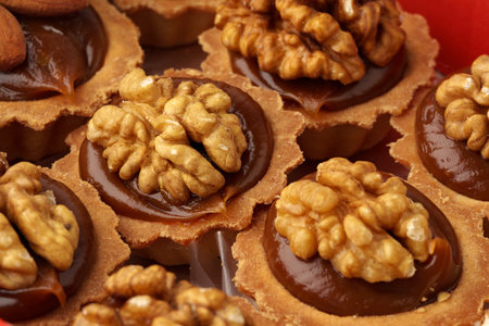 Delicious walnut pastries topped with rich chocolate filling and perfectly toasted nuts