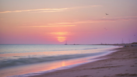 Sunset at the beach with soft waves and tranquil colors during evening hoursの素材