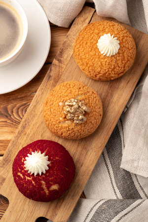 Delightful dessert platter featuring cream-topped treats served with coffee on rustic wooden table