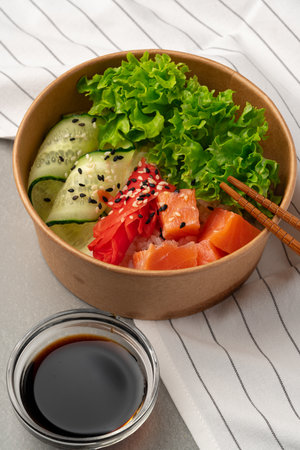 Fresh sushi bowl with salmon, avocado, and greens served with soy sauceの写真素材