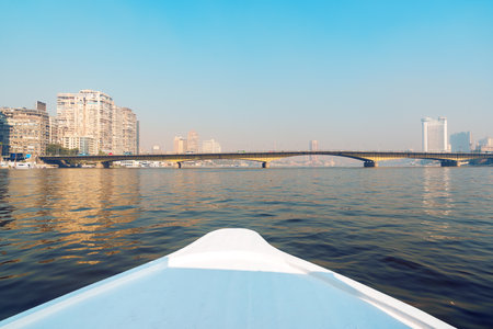 View from a boat on the river with city skyline and bridge during a clear dayの写真素材
