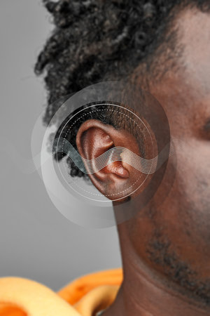 Sound waves and human connection captured in a close-up of an ear highlighting auditory perception and cultureの写真素材