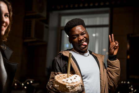 Celebration of friendship with cake at night gathering in urban settingの写真素材