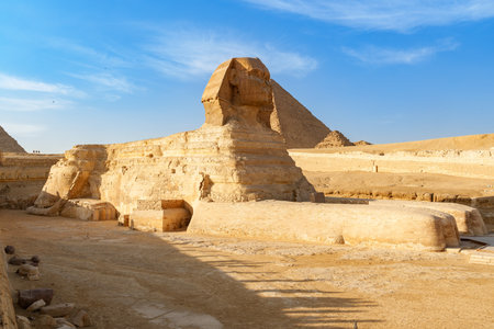 Sphinx stands majestically under clear skies at Giza in Egypt, showcasing ancient wondersの写真素材