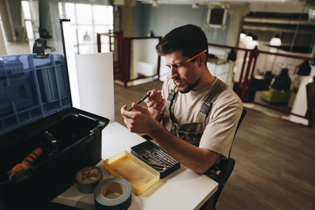 Skilled worker organizes tools while preparing for repairs in a modern office environment