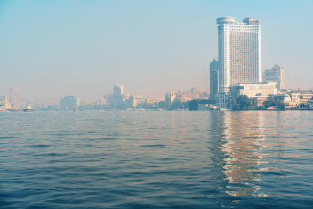Waterfront perspective of a vibrant city skyline during early morning in Cairoの写真素材