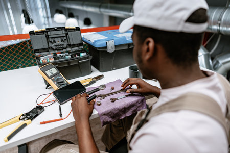 Professional technician working on tools at a workshop during the afternoonの写真素材