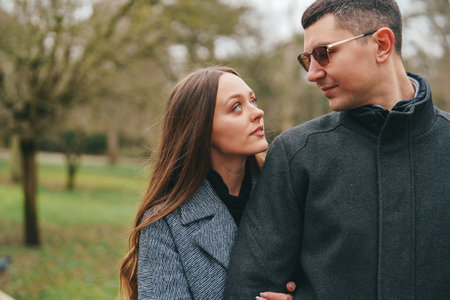 Couple enjoying a peaceful moment in a serene green park during a sunny afternoon