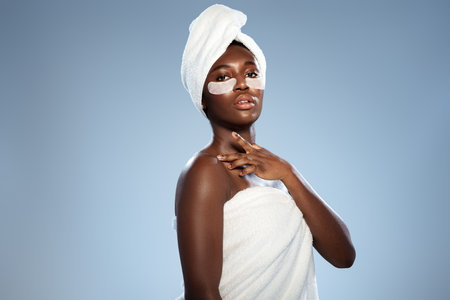 Beauty treatment with face mask and spa towel as part of self-care routine in a relaxing atmosphereの写真素材