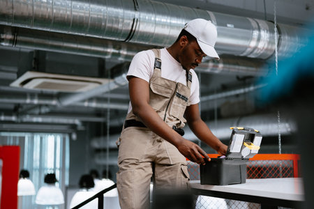 Skilled worker preparing tools in a modern workspace during the afternoonの写真素材